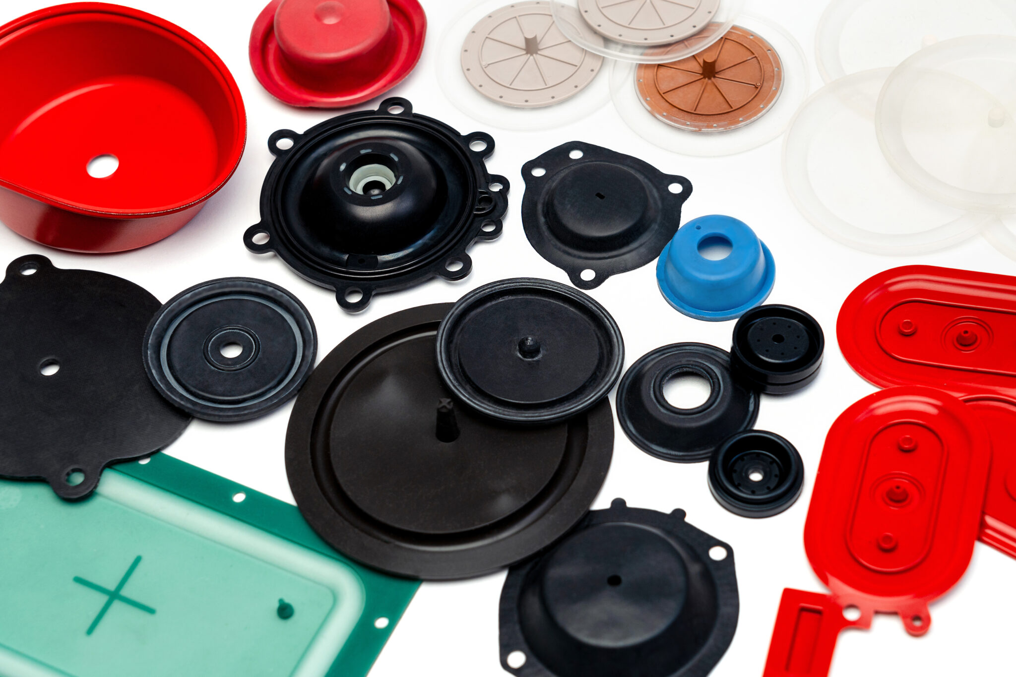 various types of pressure switch diaphragms laid out on a table